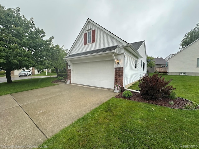 638 Eastway Cir, Lapeer, MI 48446 - view of side of property featuring brick siding, a garage, a lawn, and concrete driveway