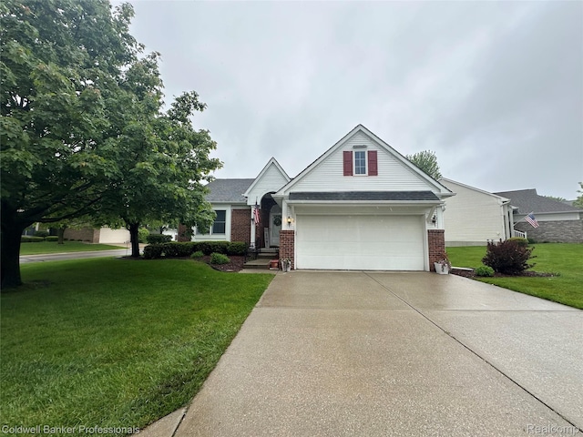 638 Eastway Cir, Lapeer, MI 48446 - view of front facade with brick siding, concrete driveway, an attached garage, and a front lawn
