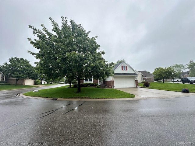 638 Eastway Cir, Lapeer, MI 48446 - view of front of property with driveway, a garage, a front lawn, and brick siding