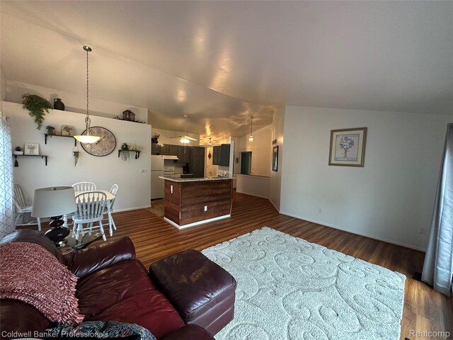 638 Eastway Cir, Lapeer, MI 48446 - living room featuring dark wood-type flooring, baseboards, lofted ceiling, and ceiling fan