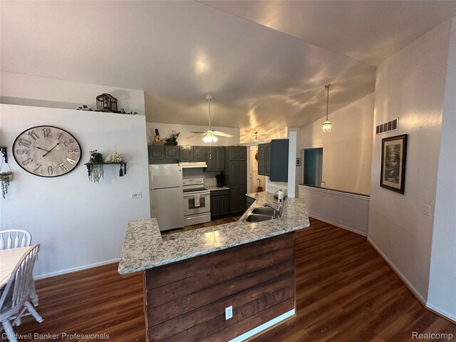 638 Eastway Cir, Lapeer, MI 48446 - kitchen featuring white appliances, under cabinet range hood, dark wood-type flooring, baseboards, and vaulted ceiling