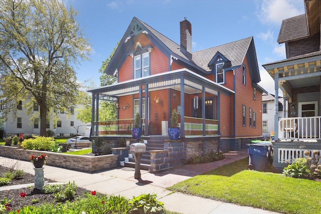 1010 6th St, Bay City, MI 48708 - victorian house with covered porch and a chimney