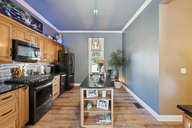 1010 6th St, Bay City, MI 48708 - kitchen featuring gas range, a sink, dishwasher, tasteful backsplash, and dark stone counters