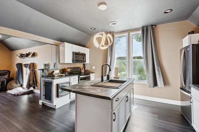 1010 6th St, Bay City, MI 48708 - kitchen featuring stainless steel appliances, dark countertops, vaulted ceiling, a sink, and dark wood-style flooring