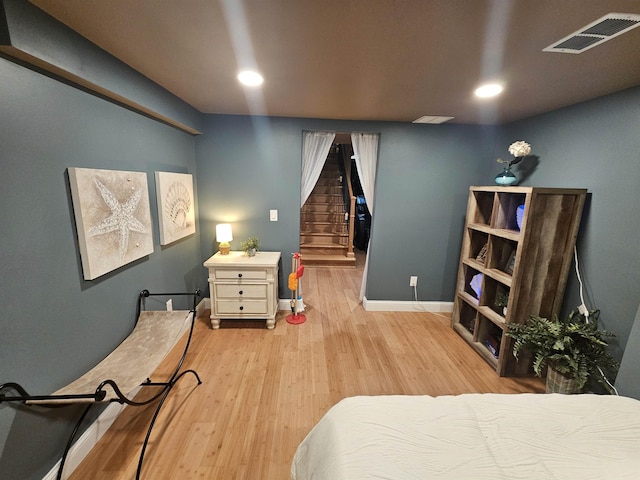 1010 6th St, Bay City, MI 48708 - bedroom with light wood-style flooring, baseboards, and recessed lighting