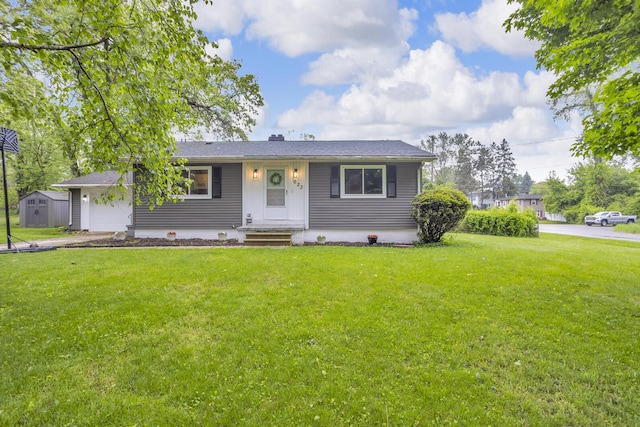 623 Pawnee St, Jackson, MI 49203 - view of front facade with a front yard and a garage