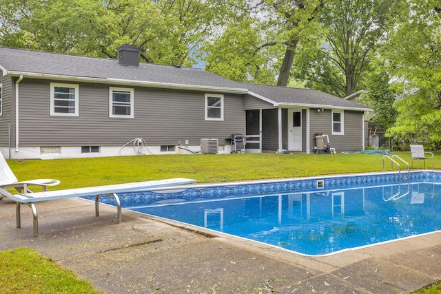 623 Pawnee St, Jackson, MI 49203 - swimming pool featuring a yard, a patio, and central air condition unit
