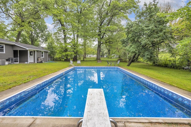 623 Pawnee St, Jackson, MI 49203 - outdoor pool with a diving board, a yard, cooling unit, and view of scattered trees