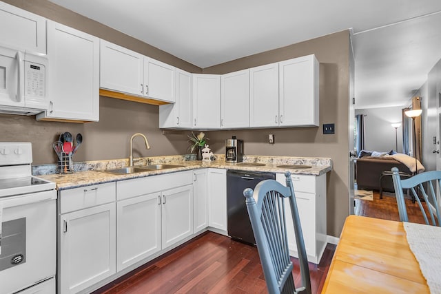 623 Pawnee St, Jackson, MI 49203 - kitchen with white appliances, a sink, dark wood-style flooring, white cabinetry, and light stone countertops