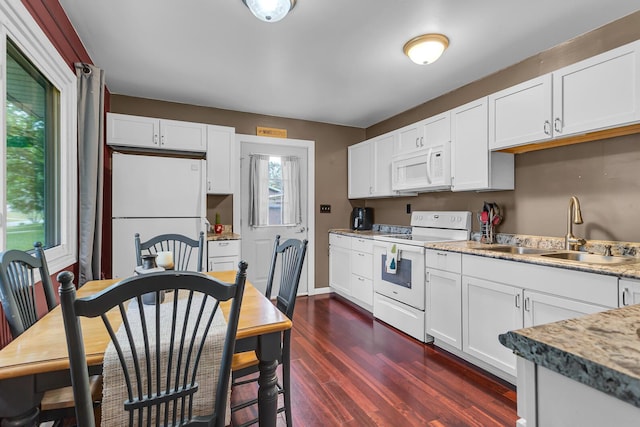 623 Pawnee St, Jackson, MI 49203 - kitchen with white appliances, a sink, dark wood-type flooring, and white cabinets