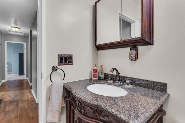 623 Pawnee St, Jackson, MI 49203 - bathroom featuring vanity, wood finished floors, and baseboards