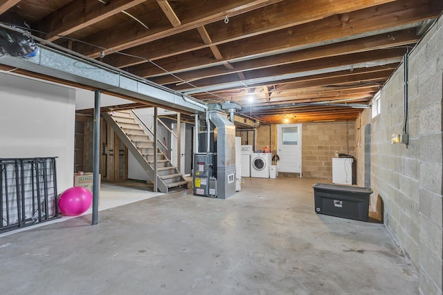 623 Pawnee St, Jackson, MI 49203 - unfinished basement featuring washer and dryer, stairway, heating unit, and concrete block wall