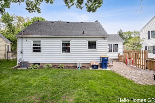2052 Gorham Dr SE, East Grand Rapids, MI 49506 - back of property with a shingled roof, a patio area, and cooling unit
