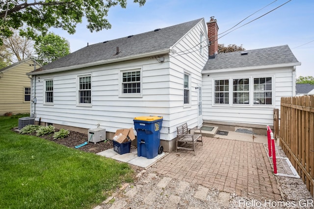 2052 Gorham Dr SE, East Grand Rapids, MI 49506 - back of house with a patio area, roof with shingles, and a chimney