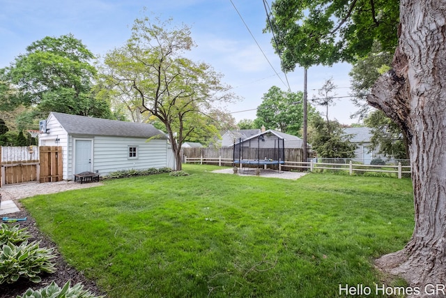 2052 Gorham Dr SE, East Grand Rapids, MI 49506 - view of yard featuring a trampoline, a fire pit, and an outdoor structure