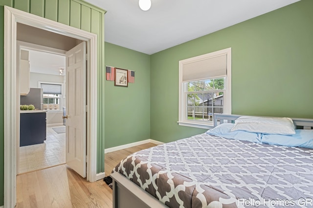 2052 Gorham Dr SE, East Grand Rapids, MI 49506 - bedroom with multiple windows, light wood finished floors, and baseboards