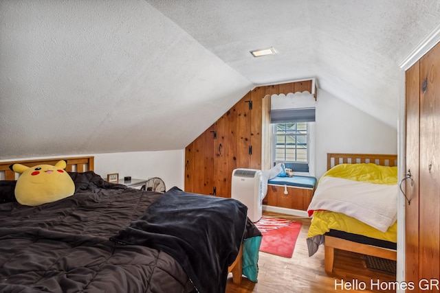 2052 Gorham Dr SE, East Grand Rapids, MI 49506 - bedroom featuring a textured ceiling, wood finished floors, and lofted ceiling