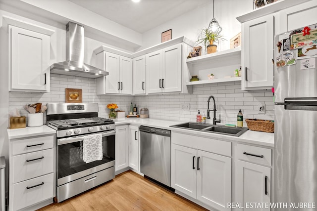 392 Harbor Town Ct Unit 2, Holland, MI 49423 - kitchen with appliances with stainless steel finishes, wall chimney exhaust hood, a sink, and light countertops