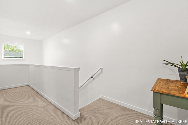 392 Harbor Town Ct Unit 2, Holland, MI 49423 - hallway featuring light carpet, an upstairs landing, baseboards, and recessed lighting
