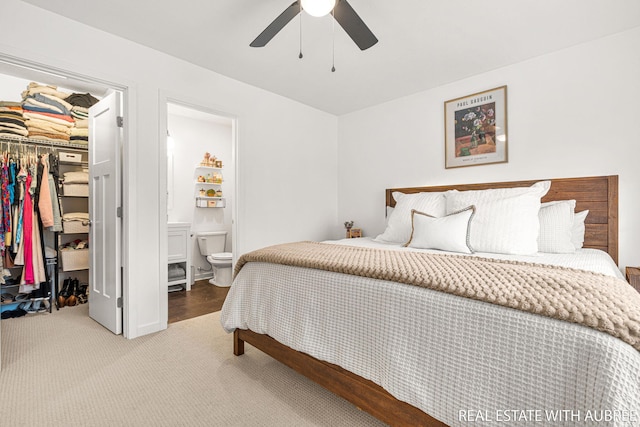 392 Harbor Town Ct Unit 2, Holland, MI 49423 - bedroom featuring a closet, a walk in closet, carpet, ensuite bathroom, and ceiling fan