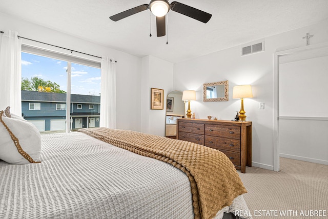 392 Harbor Town Ct Unit 2, Holland, MI 49423 - bedroom with light colored carpet, baseboards, a ceiling fan, and access to outside