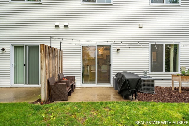 392 Harbor Town Ct Unit 2, Holland, MI 49423 - back of house with central AC unit, a patio area, and a yard