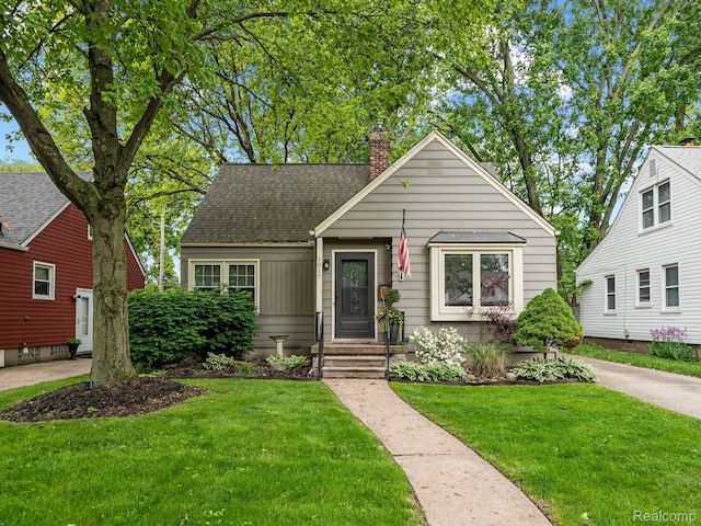 1017 N Connecticut Ave, Royal Oak, MI 48067 - bungalow featuring a chimney, a front yard, and roof with shingles