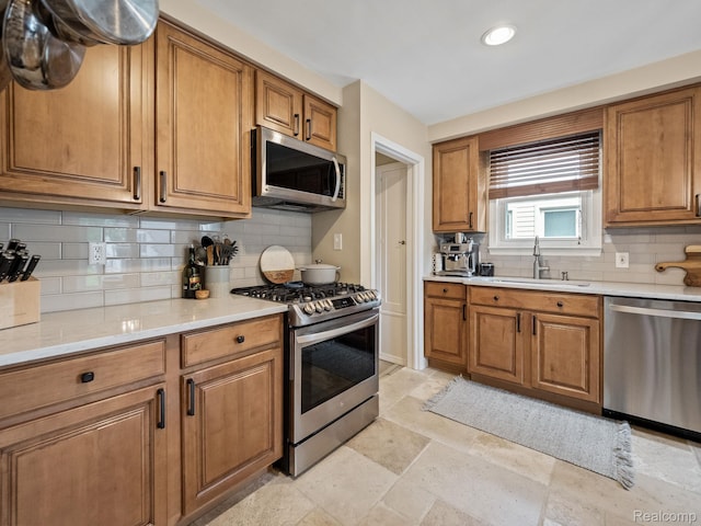 1017 N Connecticut Ave, Royal Oak, MI 48067 - kitchen with appliances with stainless steel finishes, a sink, brown cabinetry, decorative backsplash, and light countertops