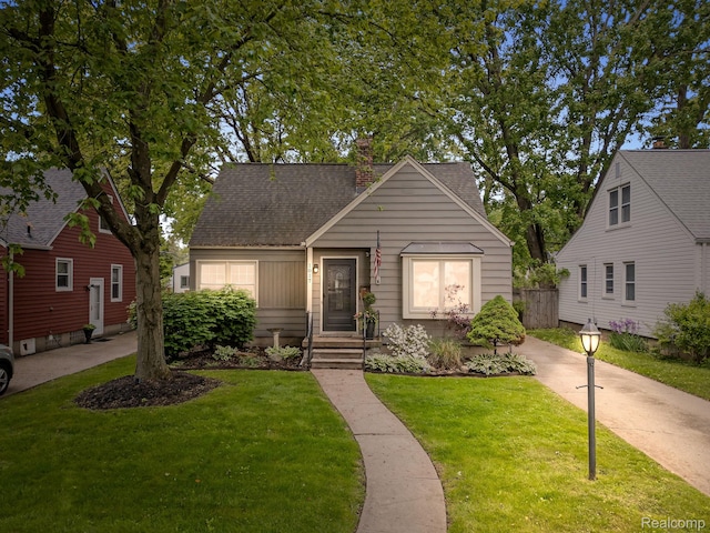 1017 N Connecticut Ave, Royal Oak, MI 48067 - bungalow-style home with a front yard, a chimney, and roof with shingles