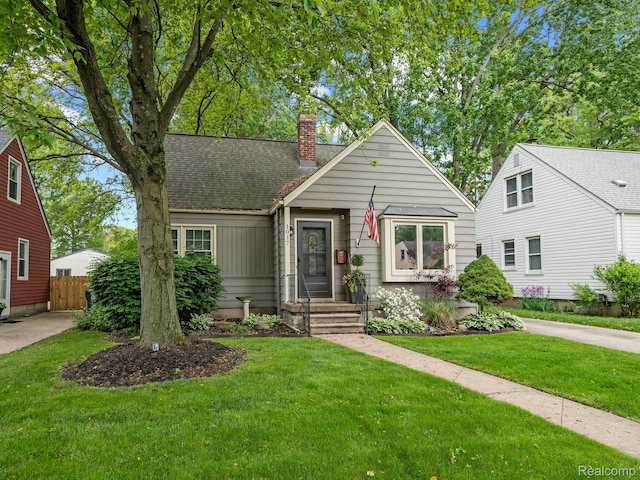 1017 N Connecticut Ave, Royal Oak, MI 48067 - view of front of house featuring a chimney and a shingled roof