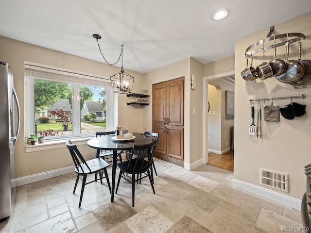1017 N Connecticut Ave, Royal Oak, MI 48067 - dining space with stone tile floors, a chandelier, and baseboards