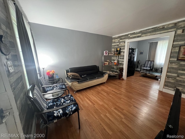 6101 Auburn St, Detroit, MI 48228 - living room with wood finished floors, wallpapered walls, and an accent wall