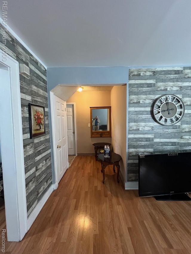 6101 Auburn St, Detroit, MI 48228 - corridor featuring an accent wall, wood finished floors, and baseboards