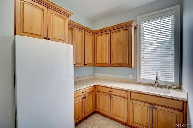 2571 N Long Lake Rd, Fenton, MI 48430 - kitchen featuring a sink, freestanding refrigerator, healthy amount of natural light, and light countertops