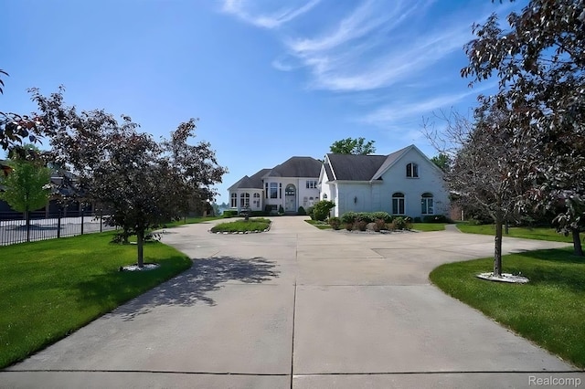 2571 N Long Lake Rd, Fenton, MI 48430 - french provincial home featuring curved driveway and stucco siding