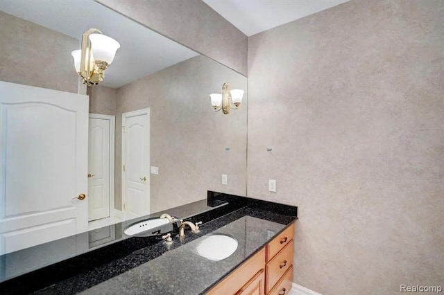 2571 N Long Lake Rd, Fenton, MI 48430 - bathroom featuring a chandelier, vanity, and baseboards
