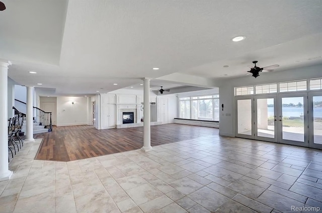 2571 N Long Lake Rd, Fenton, MI 48430 - unfurnished living room with ornate columns, a ceiling fan, a glass covered fireplace, a baseboard radiator, and recessed lighting
