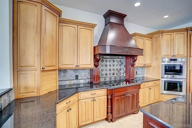 2571 N Long Lake Rd, Fenton, MI 48430 - kitchen with stainless steel double oven, custom range hood, black electric cooktop, dark stone countertops, and decorative backsplash