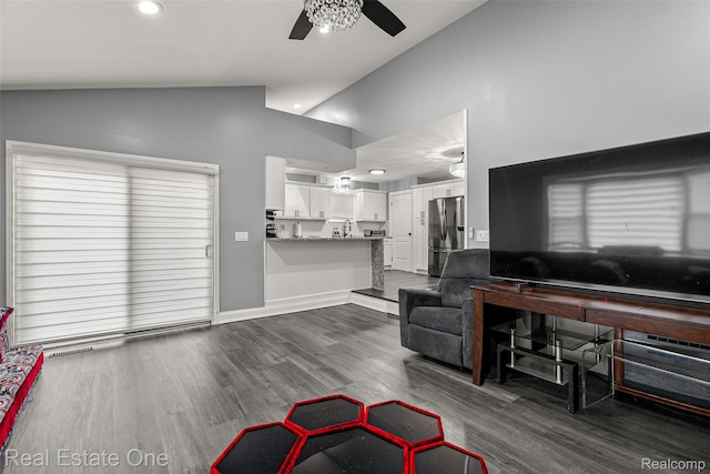 15237 Oceana Ave, Allen Park, MI 48101 - living area featuring vaulted ceiling, a ceiling fan, dark wood-style flooring, and baseboards