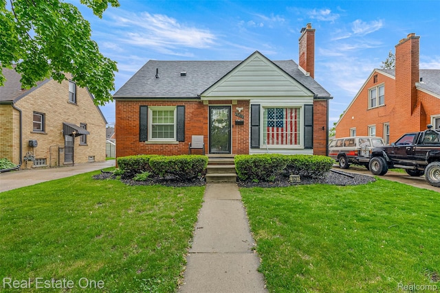 15237 Oceana Ave, Allen Park, MI 48101 - bungalow-style house featuring a front yard, brick siding, and roof with shingles