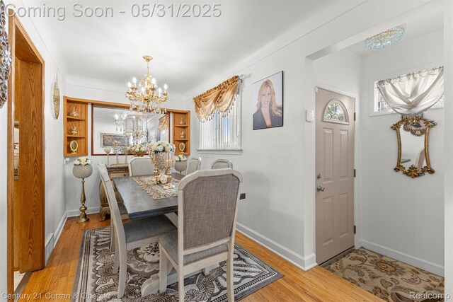 15210 Russell Ave, Allen Park, MI 48101 - dining area with a chandelier, wood finished floors, baseboards, and healthy amount of natural light
