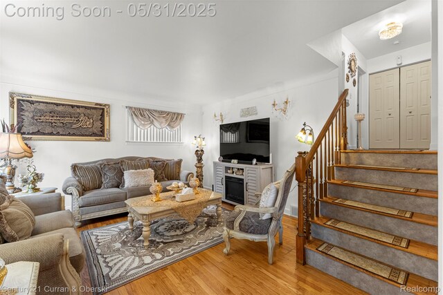15210 Russell Ave, Allen Park, MI 48101 - living room featuring a fireplace, stairway, and wood finished floors