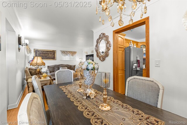 15210 Russell Ave, Allen Park, MI 48101 - dining space with wood finished floors and a chandelier