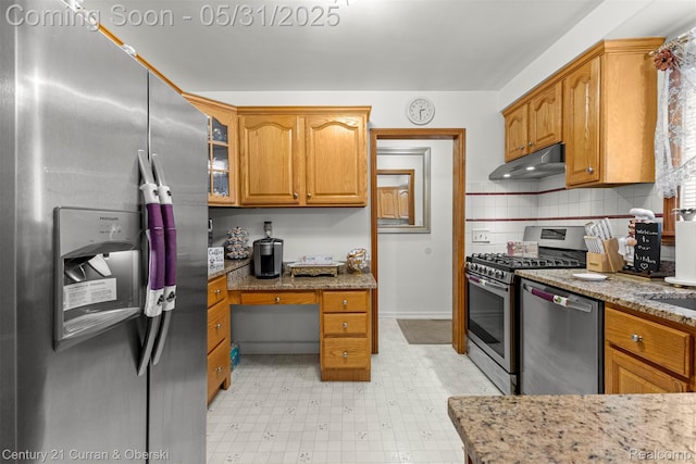 15210 Russell Ave, Allen Park, MI 48101 - kitchen featuring appliances with stainless steel finishes, under cabinet range hood, light stone countertops, brown cabinets, and light flooring