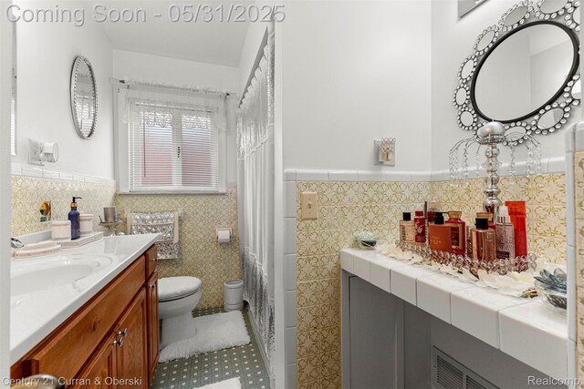 15210 Russell Ave, Allen Park, MI 48101 - full bath with vanity, wainscoting, tile walls, toilet, and tile patterned floors