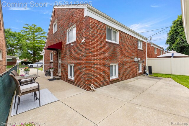 15210 Russell Ave, Allen Park, MI 48101 - view of side of property featuring brick siding, a patio, and central AC