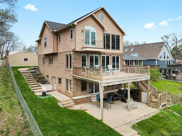 11589 Ember, Davisburg, MI 48350 - back of house with stairway, a wooden deck, a patio, and brick siding