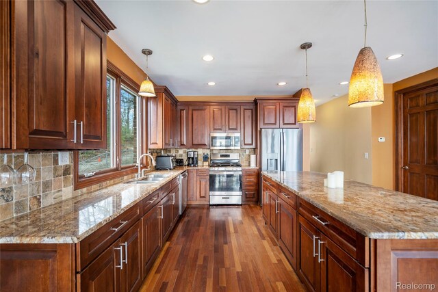 11589 Ember, Davisburg, MI 48350 - kitchen featuring stainless steel appliances, a sink, dark wood-type flooring, tasteful backsplash, and light stone counters
