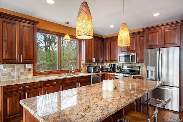 11589 Ember, Davisburg, MI 48350 - kitchen with appliances with stainless steel finishes, a sink, light stone countertops, recessed lighting, and pendant lighting