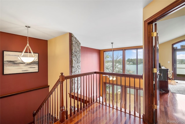 11589 Ember, Davisburg, MI 48350 - corridor featuring healthy amount of natural light, wood finished floors, and an upstairs landing